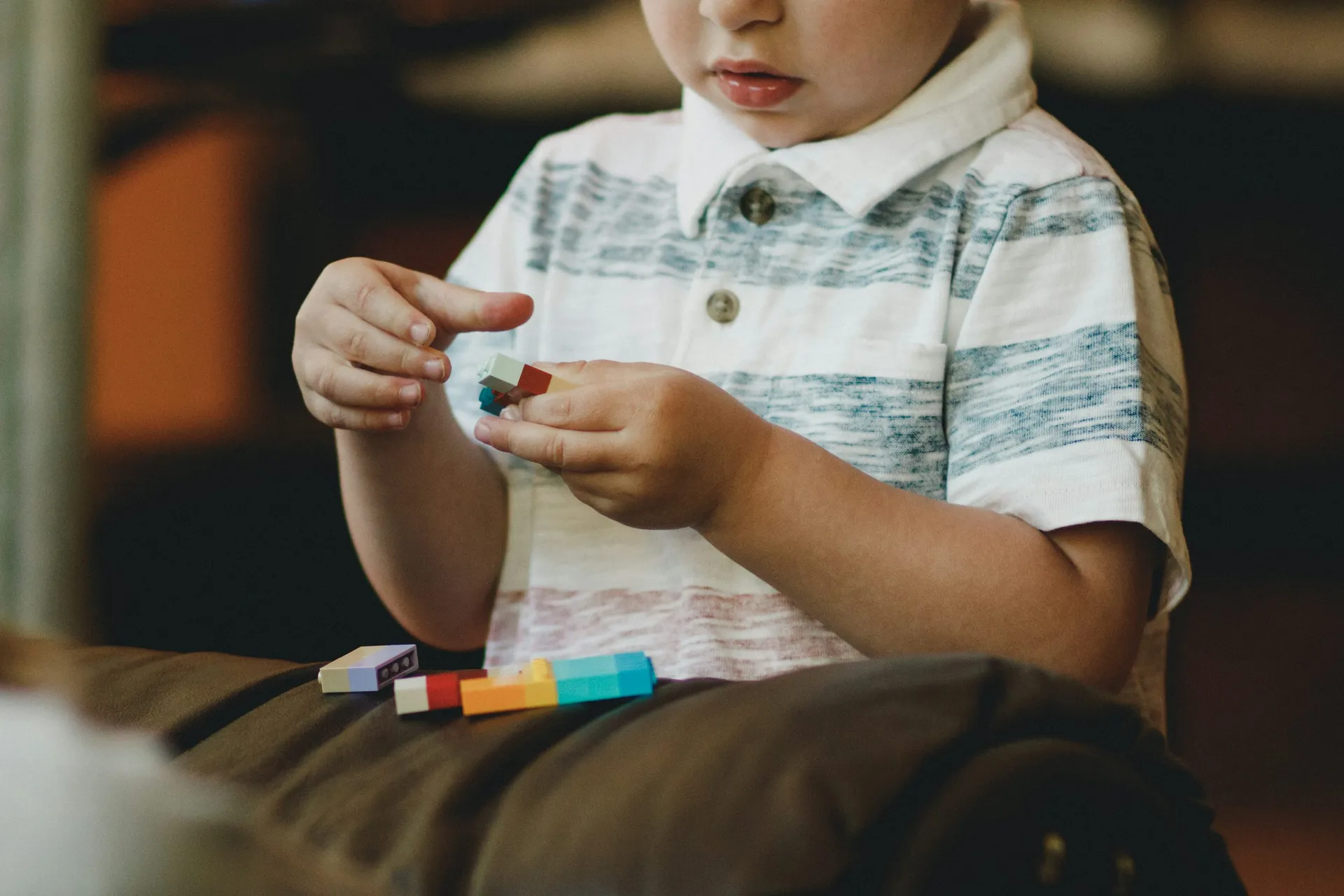 A pediatric therapist guiding a happy child through a developmental activity